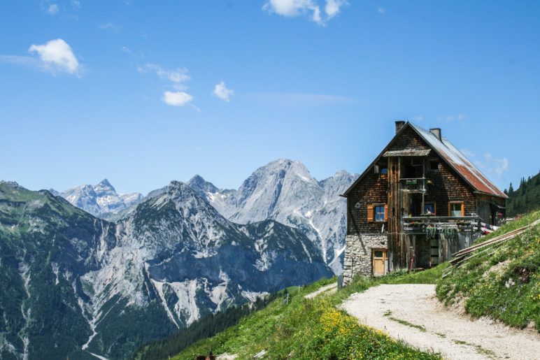 Die Plumsjochhütte mit den Karwendelbergen im Hintergrund